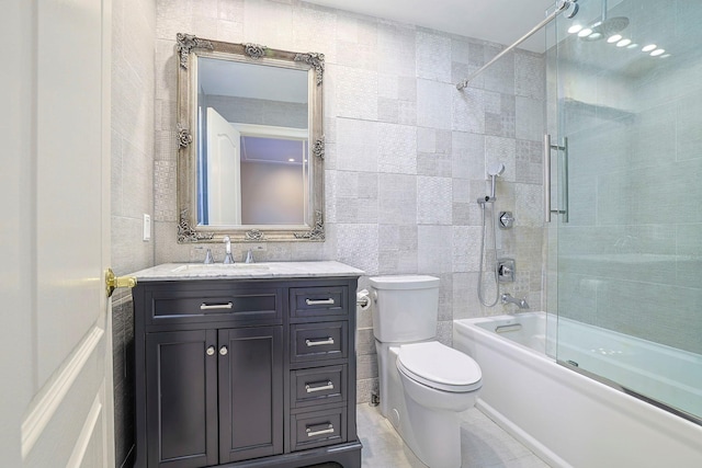 full bath featuring bathtub / shower combination, tile walls, toilet, and vanity