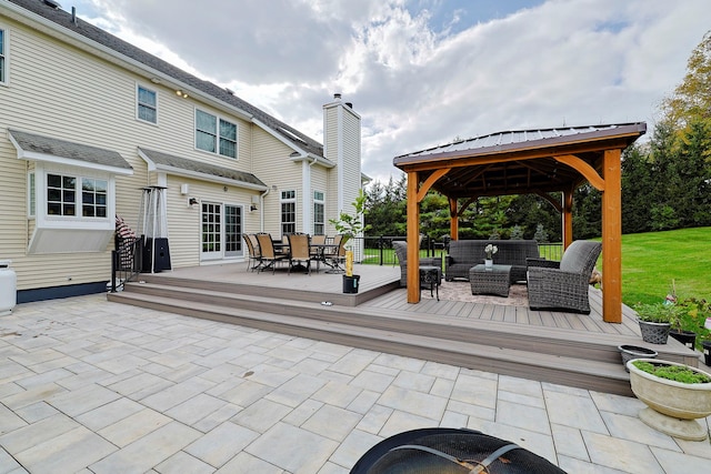 view of patio / terrace with outdoor dining space, a wooden deck, an outdoor living space, and a gazebo