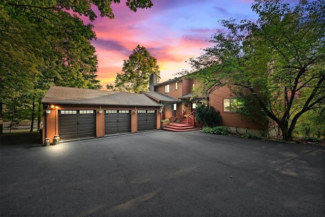 garage with aphalt driveway