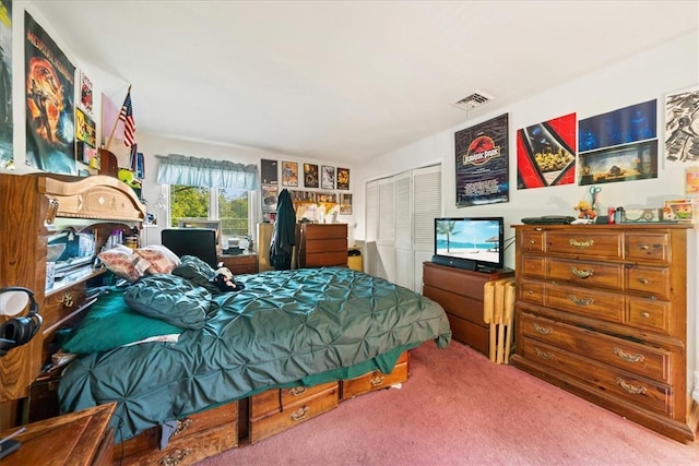 carpeted bedroom with a closet and visible vents