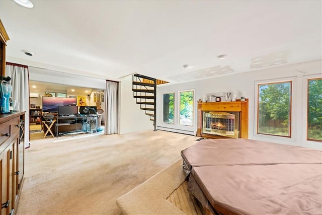 bedroom with a warm lit fireplace and light carpet