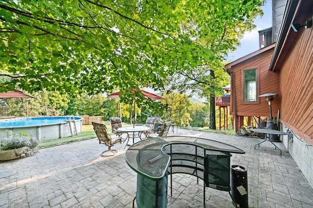 view of patio / terrace featuring outdoor dining space and an outdoor pool