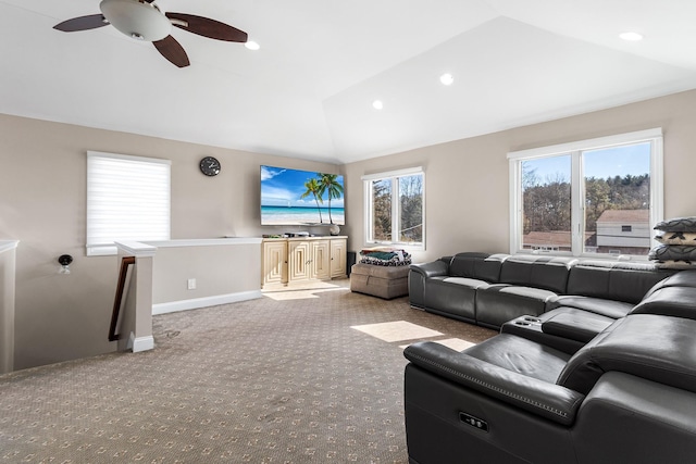 living area with lofted ceiling, a healthy amount of sunlight, baseboards, and light colored carpet