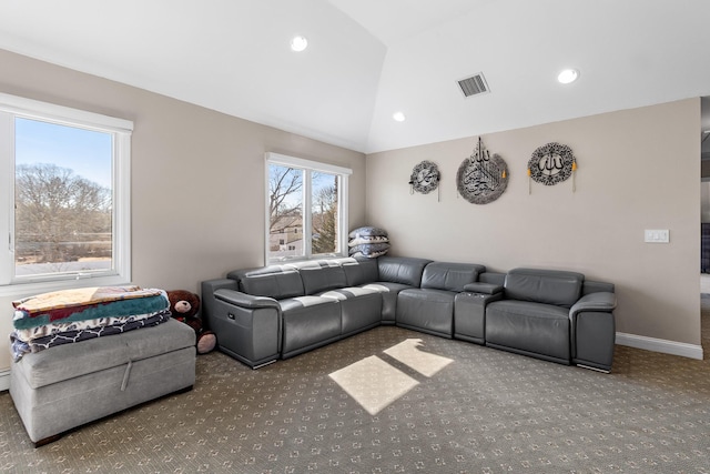 living area featuring lofted ceiling, carpet, visible vents, and a wealth of natural light