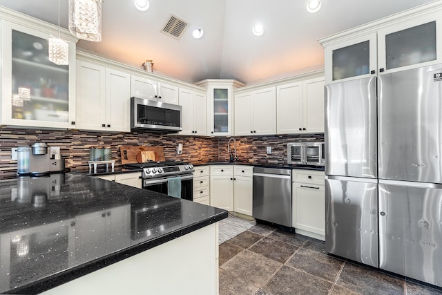 kitchen featuring visible vents, hanging light fixtures, backsplash, appliances with stainless steel finishes, and white cabinets