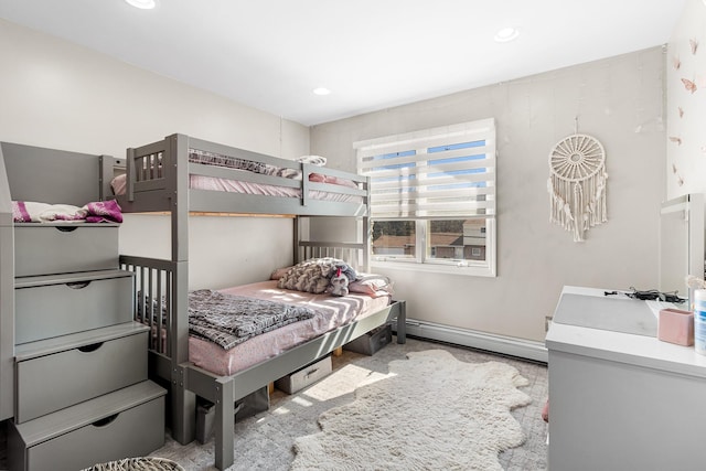 bedroom featuring a baseboard heating unit, recessed lighting, and baseboards