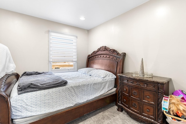 bedroom featuring light carpet