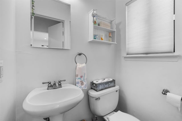 half bathroom featuring a sink and toilet