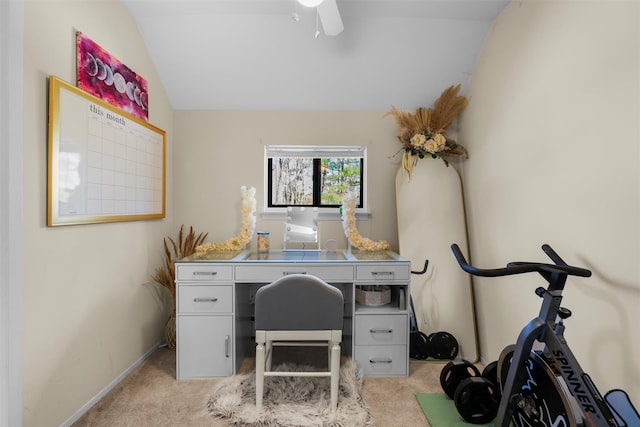 home office with a ceiling fan, vaulted ceiling, light colored carpet, and baseboards