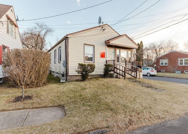 view of front of property with covered porch and a front lawn