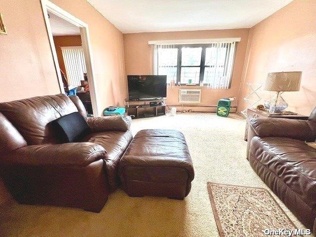 carpeted living room with a wall mounted air conditioner