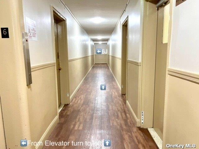 hallway with wainscoting and wood finished floors