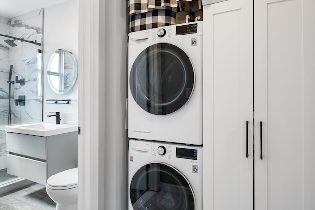 laundry room featuring laundry area and stacked washer / dryer