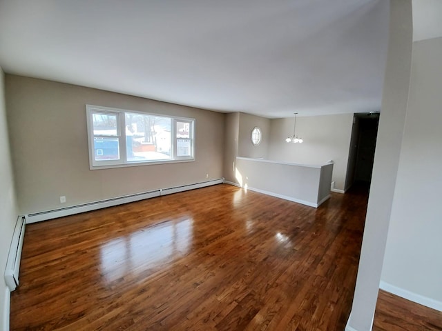 unfurnished room with a notable chandelier, dark wood finished floors, a baseboard radiator, a baseboard heating unit, and baseboards