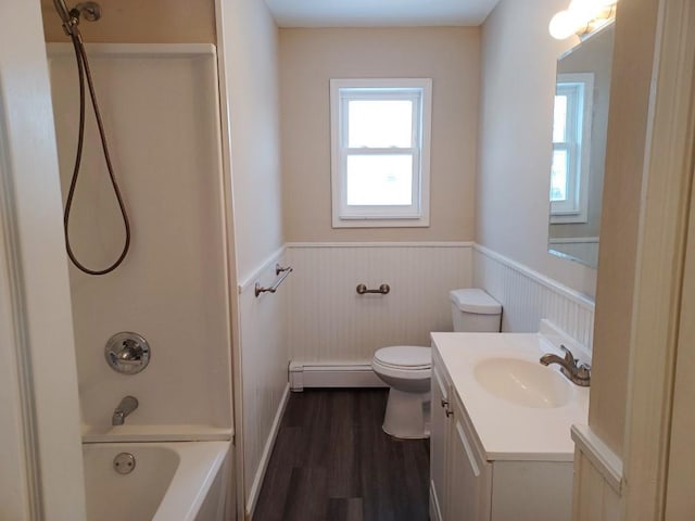 bathroom featuring vanity, baseboard heating, wood finished floors, and wainscoting