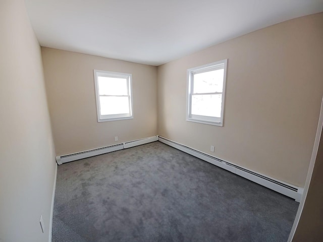 unfurnished room featuring baseboard heating, plenty of natural light, and carpet flooring