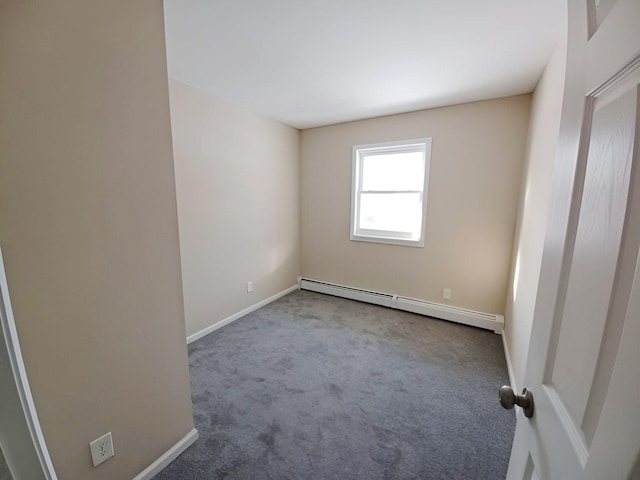 empty room with baseboard heating, carpet flooring, and baseboards