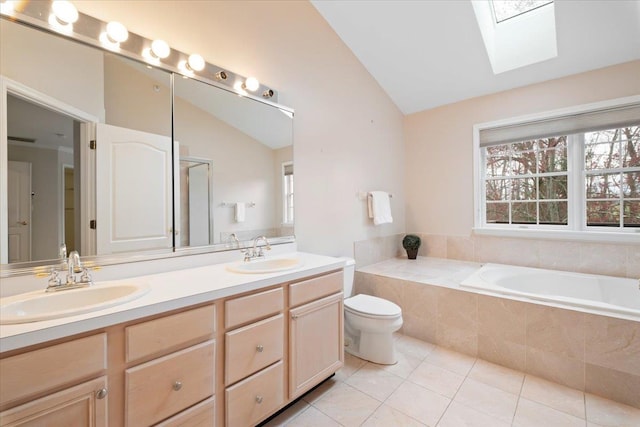 bathroom featuring a sink, tile patterned floors, lofted ceiling with skylight, and a garden tub