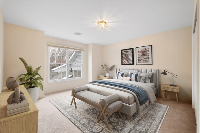 bedroom featuring light colored carpet, baseboards, and visible vents