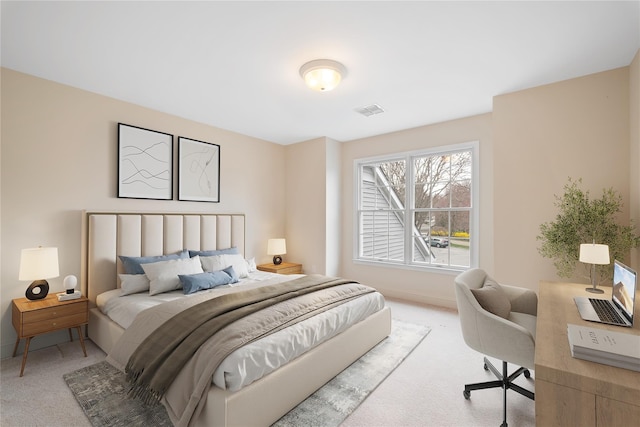 bedroom featuring visible vents, light colored carpet, and baseboards