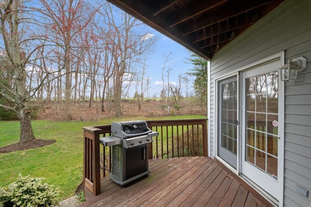 deck featuring a grill and a yard