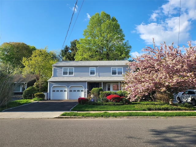 view of front of home with a garage and aphalt driveway