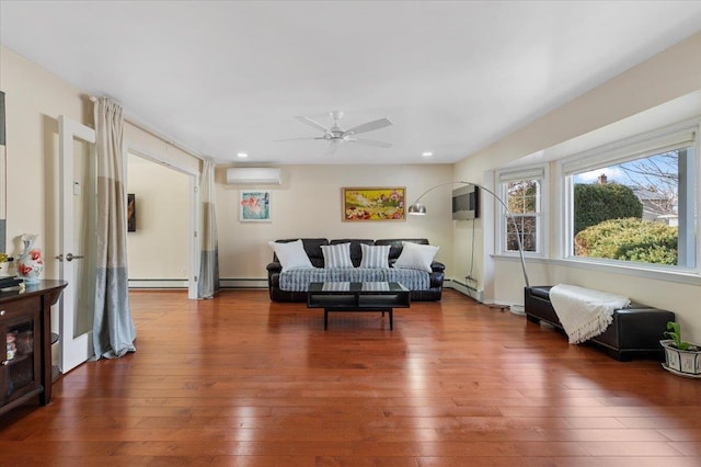 living room featuring recessed lighting, a wall mounted air conditioner, and hardwood / wood-style floors