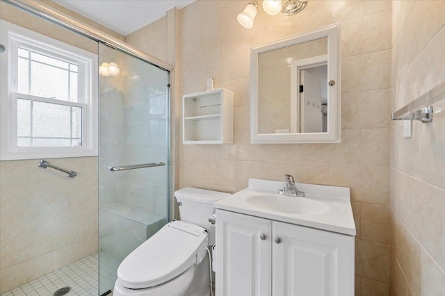 full bathroom featuring toilet, a stall shower, vanity, and tile walls