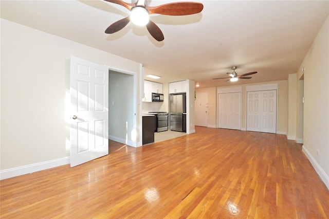 unfurnished living room featuring light wood-type flooring, a ceiling fan, and baseboards