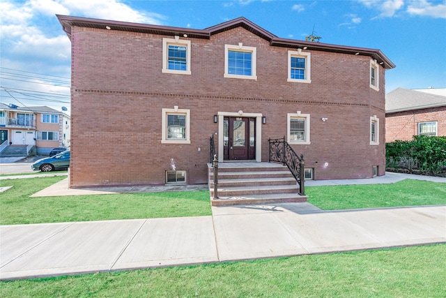 view of front of home featuring a front yard and brick siding