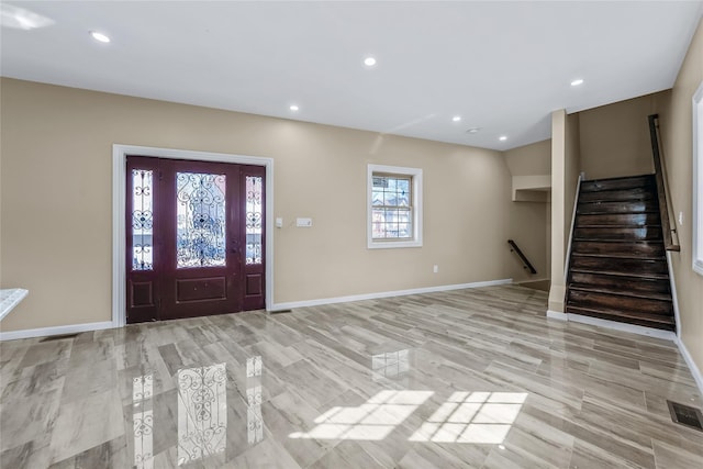 foyer entrance featuring baseboards, visible vents, and recessed lighting