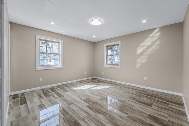 unfurnished room with a healthy amount of sunlight, baseboards, and recessed lighting