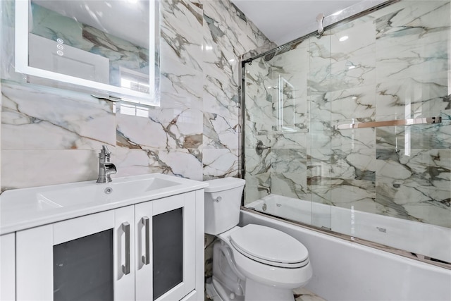 full bath with enclosed tub / shower combo, vanity, toilet, and tile walls