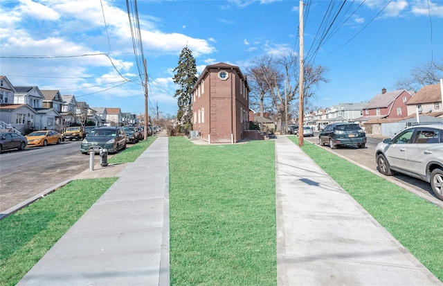 view of street with sidewalks and a residential view