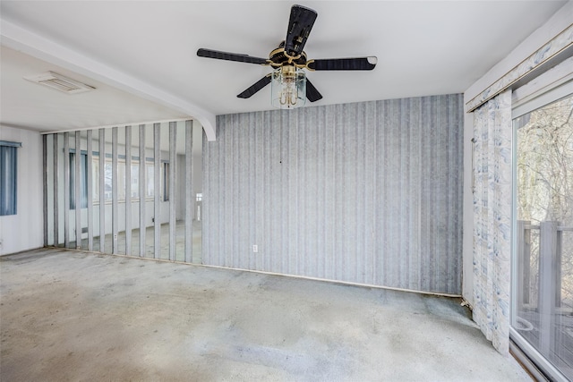 unfurnished room featuring concrete flooring, visible vents, and beamed ceiling