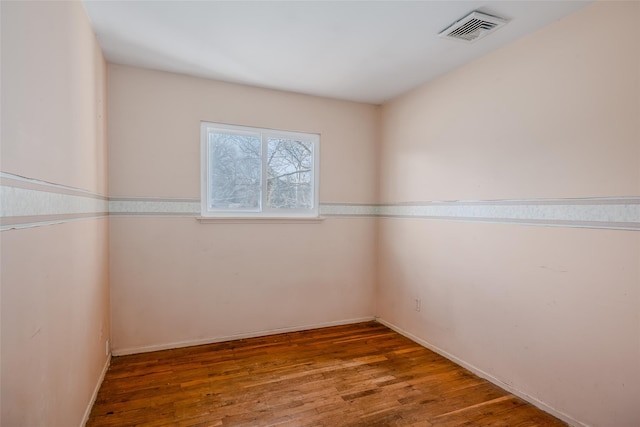 empty room with visible vents and wood finished floors