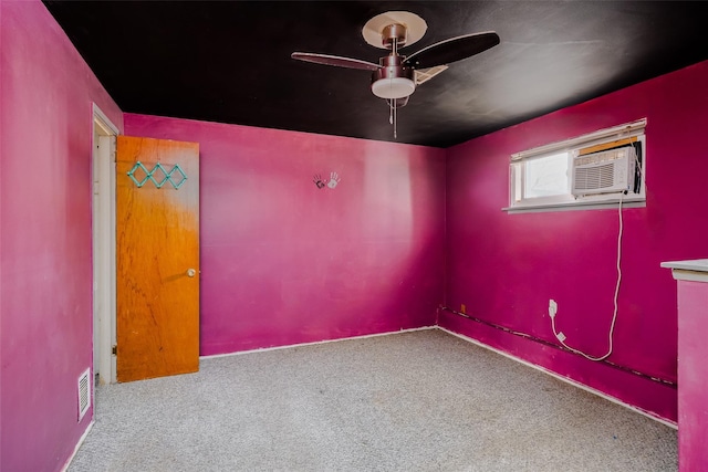 carpeted empty room with visible vents and ceiling fan