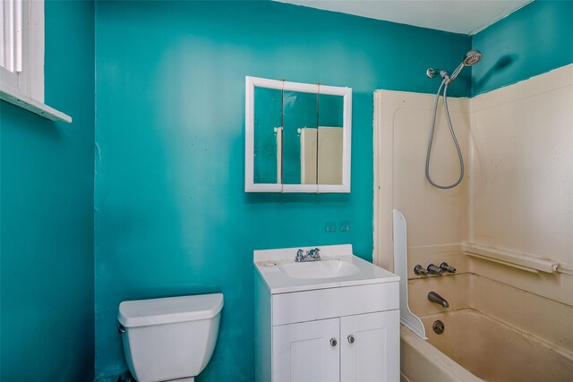 bathroom featuring toilet, tub / shower combination, and vanity