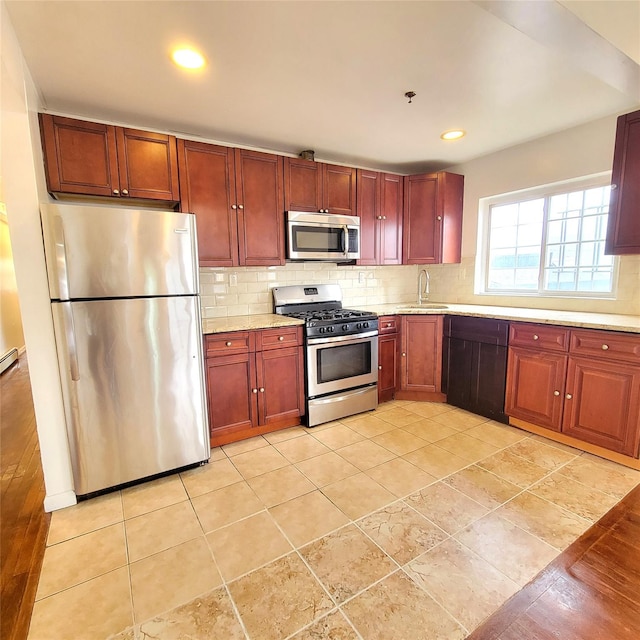 kitchen with tasteful backsplash, recessed lighting, appliances with stainless steel finishes, a sink, and dark brown cabinets