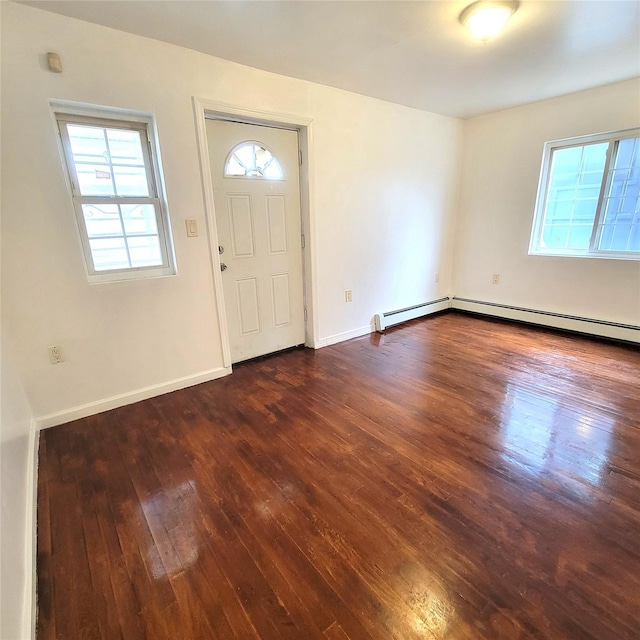 foyer entrance with baseboards and wood finished floors