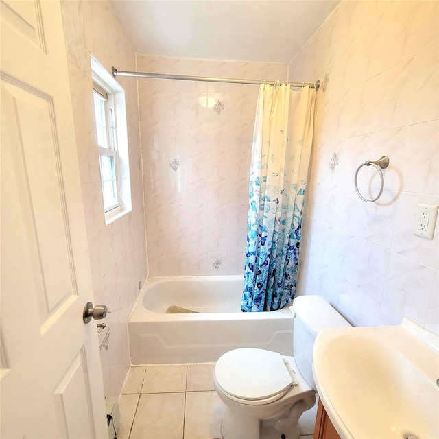 bathroom with toilet, vanity, tile walls, tile patterned floors, and shower / tub combo with curtain