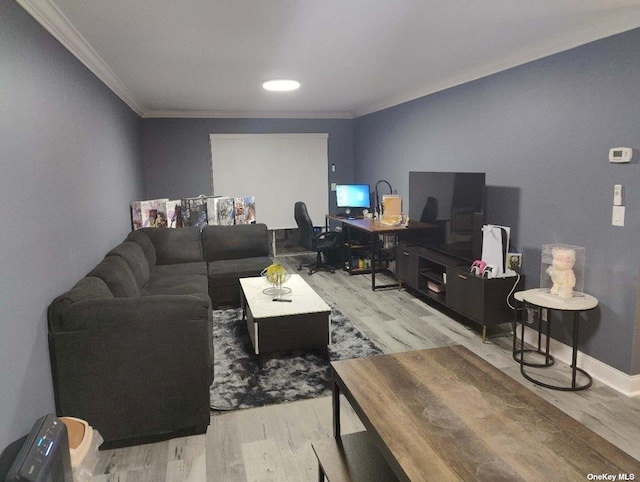 living room featuring ornamental molding, wood finished floors, and baseboards