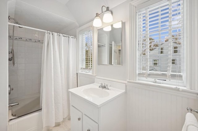 full bathroom featuring wainscoting, vanity, and shower / bath combo