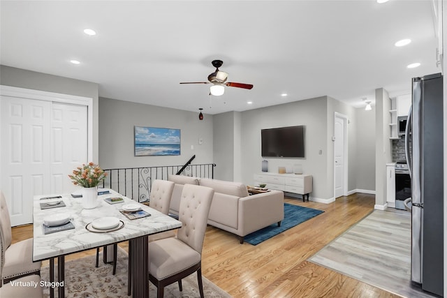 dining area with light wood-style floors, baseboards, a ceiling fan, and recessed lighting