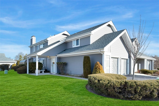 view of front of home with a garage, a front yard, a shingled roof, and driveway