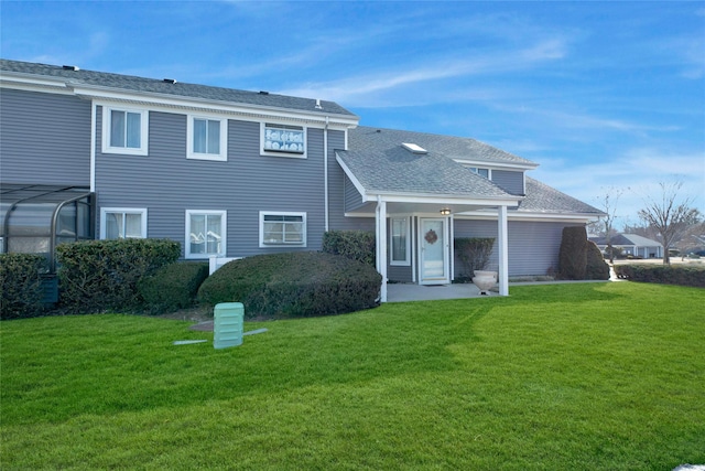 view of front of home with a front yard and roof with shingles