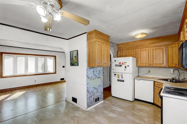 kitchen with white appliances, a sink, visible vents, baseboards, and light countertops