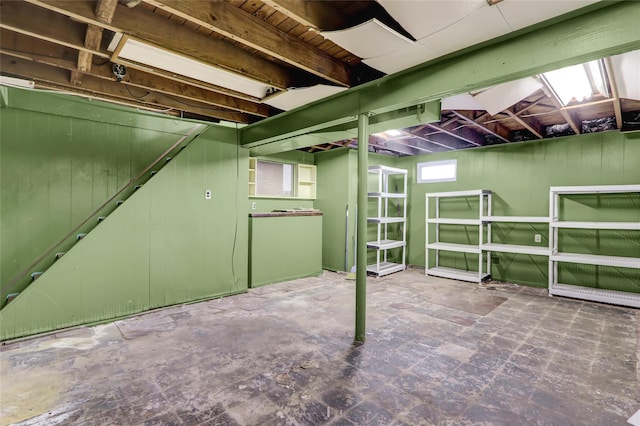 basement featuring wood walls