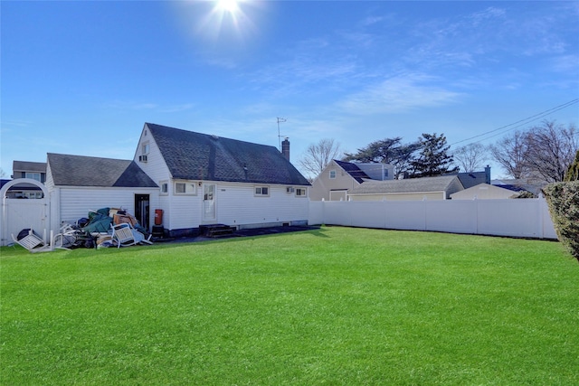 view of yard featuring entry steps and a fenced backyard