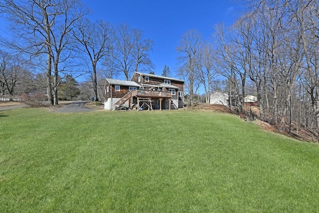 view of yard with stairs and a wooden deck